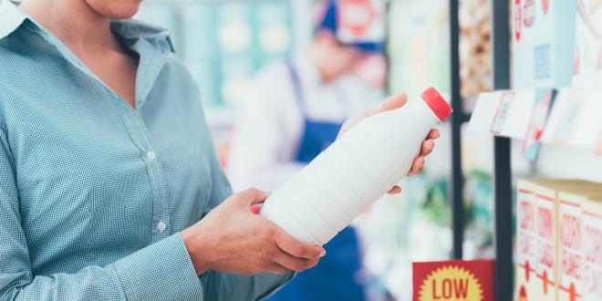 a woman reading labels in the grocery store