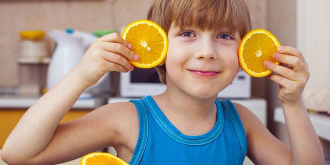 child with oranges