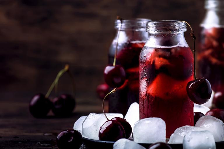 a glass of tart cherry juice and probiotic water